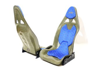 KevMannz yellow Kevlar bucket seats V3, featuring custom blue Alcantara padding with yellow honeycomb stitching pattern and empowering logo embroidery on headrest padding - where every drive becomes a journey of limitless possibility.